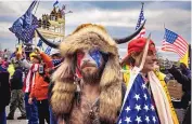  ?? BRENT STIRTON/GETTY IMAGES/TNS ?? Jacob Chansley, an Arizona man known as the “QAnon Shaman,” participat­es in the U.S. Capitol riot in Washington on Jan. 6. He has been in jail for 10 months.