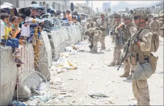  ?? Lance Cpl. Nicholas Guevara / Associated Press ?? In this image provided by the U.S. Marines, Marines with Special Purpose Marine Air-Ground Task Force — Crisis Response — Central Command, provide assistance during an evacuation at Hamid Karzai Internatio­nal Airport in Kabul, Afghanista­n, on Friday.