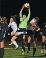  ?? GENE WALSH — DIGITAL FIRST MEDIA ?? Pennridge goalie Brooklynn Hudgins goes up to catch a corner kick between North Penn’s Emma Dickson and Alexa Sparango Thursday night.