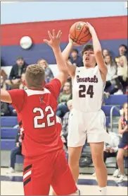  ??  ?? Heritage’s Brady Chandler pulls up for a shot as Lakeview’s Bryce Goins goes for a block.