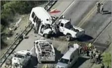  ?? KABB/WOAI VIA AP ?? In this aerial image made from a video provided by KABB/ WOAI authoritie­s respond to a deadly crash involving a van carrying church members and a pickup truck on U.S. 83 outside Garner State Park in northern Uvalde County, Texas, Wednesday, March 29,...