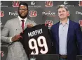  ?? AP ?? Miles Murphy poses with Bengals coach Zac Taylor during Murphy’s introducto­ry news conference last April after the Bengals selected him in the NFL Draft.