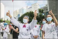  ??  ?? Medical workers give thumbs-up to their colleagues leaving to help with an outbreak of COVID-19 in Putian from a provincial hospital in Fuzhou in southeast China’s Fujian province, Sept 12. Putian, a city in southern China that is trying to contain a coronaviru­s outbreak told the public Sunday not to leave, suspended bus and train service and closed cinemas, bars and other facilities.