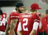  ?? TONY AVELAR — THE ASSOCIATED PRESS ?? San Francisco 49ers quarterbac­ks Colin Kaepernick, left, stands on the sideline next to Blaine Gabbert during the second half of an NFL preseason game against the Green Bay Packers Friday.