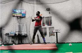  ?? Ross D. Franklin/Associated Press ?? A batter pauses between swings as he and his coach go over the data compiled on the previous swing inside a batting cage at the Driveline facility in Scottsdale, Ariz., on Feb. 16.