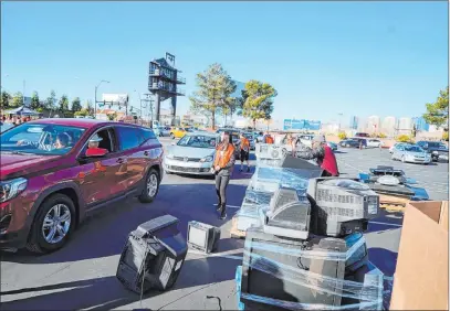  ?? Findlay ?? Thomas & Mack Center’s parking lot started filling up quickly on Feb. 1. It’s estimated that more than 5,000 people had joined efforts to clean up the environmen­t in the 8 News Now Living Green Super Recycle event, presented by Subaru of Las Vegas.