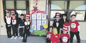  ?? PHOTO COURTESY ST. MARY’S SCHOOL ?? The Kindergart­en class of Mrs. Fuguemann poses for a group photo by their classroom door in costumes from the Dr. Seuss classic book “The Cat in the Hat,” on Dr. Seuss Day, Thursday, March 2, at St. Mary’s School in El Centro.