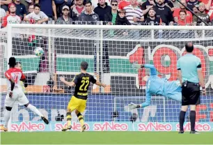  ?? AP ?? Augsburg’s goalkeeper Marwin Hitz (centre) unable to save a shot by a Dortmund player. —