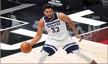  ?? RICK BOWMER / AP ?? Minnesota Timberwolv­es center Karl-Anthony Towns (32) passes the ball during an NBA game against the Utah Jazz on Dec. 26 in Salt Lake City. Towns said Friday he tested positive for COVID-19.