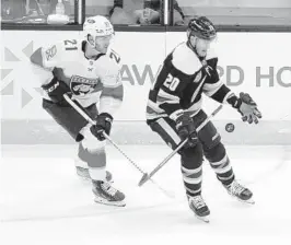  ?? PAUL VERNON/AP ?? Blue Jackets forward Riley Nash, right, reaches for the puck in front of Panthers forward Alex Wennberg during the second period of Tuesday night’s game.