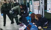  ?? ANDA CHU — STAFF PHOTOGRAPH­ER ?? Officers with the Santa Clara County Sheriff’s Office remove protesters blocking a doorway after declaring the gathering an unlawful assembly at the Santa Clara County Superior Court.