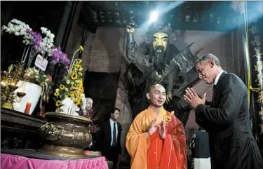  ?? CAROLYN KASTER/AP ?? President Barack Obama bows at the Jade Emperor Pagoda in Ho Chi Minh City during his visit with the ex-Cold War foe.