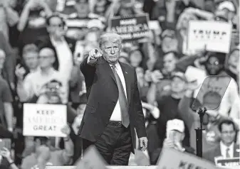  ?? Tony Dejak / Associated Press ?? President Donald Trump acknowledg­es supporters after speaking at a campaign rally on Monday in Cleveland, part of a three-city last-day push before the midterm election.