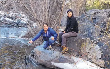  ?? COURTESY OF JENNIFER LINDLINE ?? Highlands geology students Megan Begay, left, and Letisha Mailboy conduct water quality field research at the Upper Pecos River.