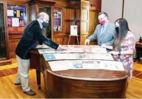  ??  ?? MSU Interim Dean of Libraries Tommy Anderson, from left, MSU Libraries Associate Dean Stephen Cunetto, and Assistant Professor and Manuscript­s Librarian Carrie Mastley look over items from the Janice Cleary Sheet Music Collection, a newly acquired addition to Mitchell Memorial Library’s Special Collection­s. (Photo by Megan Bean, MSU)