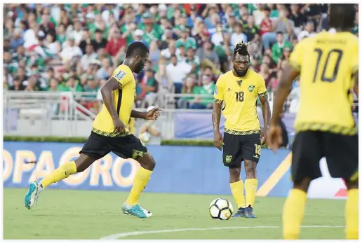  ??  ?? Jamaica’s Kemar Lawrence (20), at left, lines up his game-winning goal on a free kick in the 88th minute to defeat Mexico at the CONCACAF Gold Cup semifinal match at The Rose Bowl in Pasadena, California. (AFP)