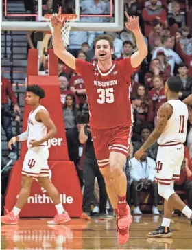  ?? ASSOCIATED PRESS ?? Wisconsin’s Nate Reuvers celebrates after the Badgers edged Indiana, 60-56, to claim a share of the Big Ten regular-season crown.