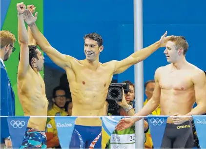  ??  ?? American Michael Phelps celebrates with teammates after winning the gold medal Saturday in the men’s 4 x 100-meter medley relay. With the victory, Phelps, who has said that this would be his final race, has a cumulative 23 gold medals.