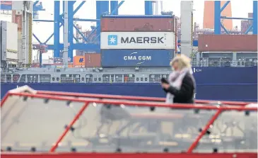  ?? BLOOMBERG ?? A sightseein­g boat passes shipping containers aboard cargo vessel Sondeborg at the port of Hamburg, Germany. Supply chain leaders need to assess and plan for how the virus will impact global supply chains.