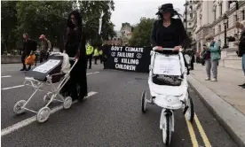  ?? Photograph: WIktor Szymanowic­z/NurPhoto/REX/Shuttersto­ck ?? Extinction Rebellion activists stage a funeral march with white painted children's prams, London, 31 August 2021.