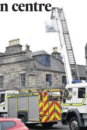  ??  ?? DAMAGED: Firefighte­rs used a height vehicle to tackle the blaze in the roof space