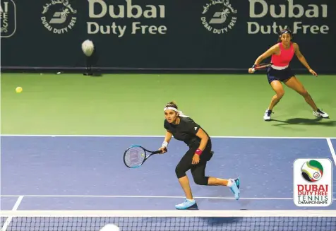  ?? Virendra Saklani/Gulf News ?? ■ Sania Mirza of India, playing along with Caroline Garcia of France, shapes up to hit a return during the first round of the women’s doubles in the Dubai Duty Free Tennis Championsh­ips yesterday. Mirza-Garcia won 6-4, 4-6, 10-8.