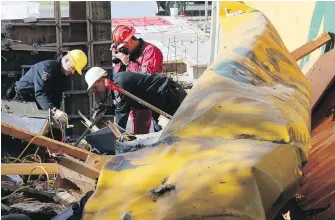  ??  ?? Police and fire personnel investigat­e an explosion at a constructi­on-site container at 935 Cloverdale Ave. on April 26, 2013.