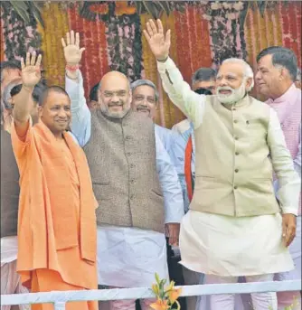  ?? AP FILE ?? PM Narendra Modi (far right) and BJP chief Amit Shah (second from left) during the swearing-in ceremony of UP CM Yogi Adityanath (in saffron robes) in 2017. The party hopes to retain its core voter base in the state despite disillusio­nment.