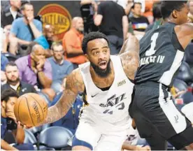  ?? MELISSA MAJCHRZAK/GETTY ?? Utah’s Stanton Kidd, a 2010 Edmondson High grad, drives to the basket during an NBA Summer League game against San Antonio. He signed a three-year deal last month.