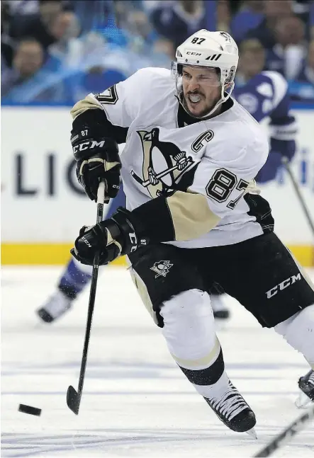  ?? MIKE CARLSON/GETTY IMAGES ?? Penguins captain Sidney Crosby has scored three game-winning goals in the playoff series against the Lightning, one short of Mike Bossy’s record set in 1983.