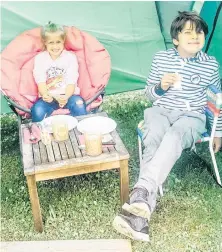  ?? CONTRIBUTE­D ?? Isabella Wadden-Cappa (left) and her friend Ty Sampiero, both seven, sit in the tent Isabella got for her birthday in the backyard of her home in Tuscany, Italy.