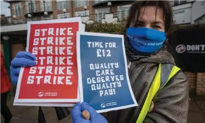  ??  ?? A member of the United Voices of the World union pickets the Sage care home in Brent, north London in a strike over sick pay on 6 February. Photograph: Guy Smallman/Getty Images