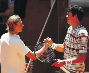  ?? CLIVE BRUNSKILL/GETTY IMAGES ?? Denis Shapovalov shakes hands with fellow Canadian Milos Raonic following the teen’s thirdround 6-4, 6-4 win at the Madrid Open on Thursday.