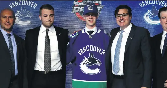  ?? BRUCE BENNETT/GETTY IMAGES ?? Swedish pivot Elias Pettersson poses for photos after being selected fifth overall by the Vancouver Canucks during the NHL draft on Friday in Chicago.