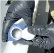  ?? RCMP PHOTO ?? In this June 27, 2016 photo, a member of the RCMP opens a printer ink bottle containing the opioid carfentani­l, imported from China, in Vancouver. City police say carfentani­l has now reached Peterborou­gh.