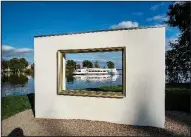  ?? AP/MICHAEL PROBST ?? A cruise ship passes Monday behind a frame for selfies at a lake in Schwerin, Germany.