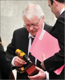  ??  ?? Veterinari­an surgeon Con Twomey pictured opening a sample urn at Macroom District Court.