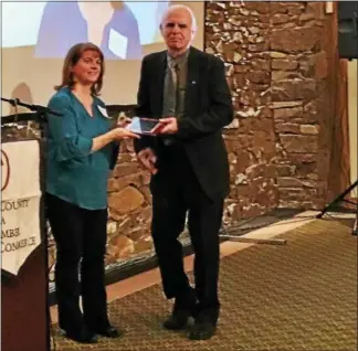  ?? REBECCA BLANCHARD — DIGITAL FIRST MEDIA ?? Library Director Susan Lopez and past board of trustees president Russ Phillips receive the James K. Boyer Quality of Life Award presented by the TriCounty Area Chamber of Commerce at the annual Boyertown Area Progress Dinner Jan. 17.