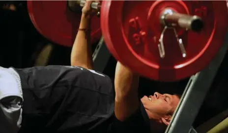  ?? COLIN MCCONNELL PHOTOS/TORONTO STAR ?? Quarterbac­k prospect Cayman Shutter gets to work on the bench press in an attempt to impress scouts at the CFL combine on Saturday.