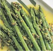  ?? Cara Howe ?? Orange and Mustard Marinated Asparagus from the book “Snacks for Dinner: Small Bites, Full Plates, Can’t Lose” by Lukas Volger