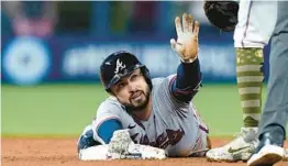  ?? LYNNE SLADKY/AP ?? The Braves’ Travis d’Arnaud is safe at second with a double during the first inning against the Marlins on Friday in Miami.