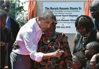  ?? Tony Karumba / AFP / Getty Images ?? Former President Barack Obama greets his step-grandmothe­r Sarah and half sister, Auma, second from right, in Kogelo in Siaya county, western Kenya. Auma Obama’s foundation is opening a sports center for youth.