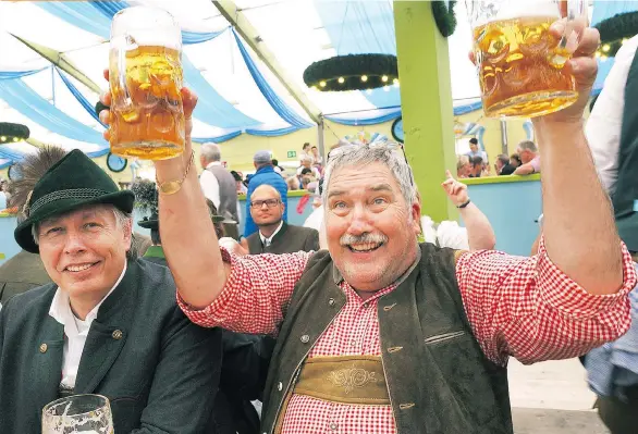  ?? PHOTOS: RICK STEVES ?? With Germany’s best beers flowing by the litre at Oktoberfes­t, Bavarians are happy to toast with friendly foreigners.