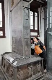  ??  ?? Visitors study the inscriptio­ns on a stele in Xi’an Beilin Museum, Shaanxi Province.