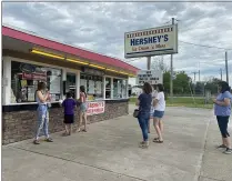  ?? LYRIC AQUINO — THE MORNING JOURNAL ?? Customers line up on social distancing markers June 3at Hershey’s Ice Cream’ n More in LaGrange.