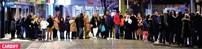  ??  ?? Waiting patiently: Shoppers wrapped up warm as they queued outside Next on Queen Street from the early hours for the start of its sale, which began at 6am yesterday CARDIFF