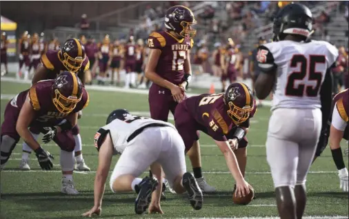  ?? READY TO GO: The Sentinel-Record/Grace Brown ?? Lake Hamilton sophomore center Brayden Aitken (56) prepares to snap the ball to quarterbac­k Grant Bearden (12) while sophomore lineman Brandon Hobby (55) and junior fullback Tevin Woodley look on during a Sept. 11 game against Malvern. The Wolves host Siloam Springs tonight.