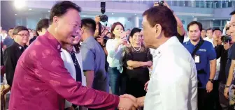  ??  ?? President Rodrigo Roa Duterte greets Chinese Ambassador to the Philippine­s Zhao Jianhua in this government photo.