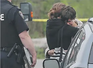  ?? PHOTOS: TONY CALDWELL ?? Marina and Ekaterina Ponomareva, the daughter and granddaugh­ter of Nelliya Karbisheva, hug after hearing that the 82-year-old had been found dead Thursday.