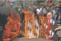  ?? MAJDI MOHAMMED/ASSOCIATED PRESS ?? Palestinia­ns burn pictures of Israeli Prime Minister Benjamin Netanyahu, from left, Abu Dhabi Crown Prince Mohammed bin Zayed al-Nahyan and U.S. President Donald Trump during a protest Friday against the United Arab Emirates’ deal with Israel, in the West Bank city of Nablus.